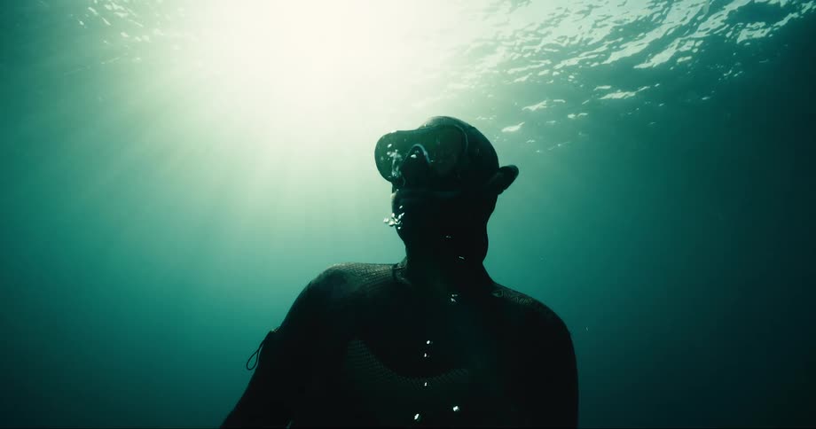 A diver slowly rises to the surface