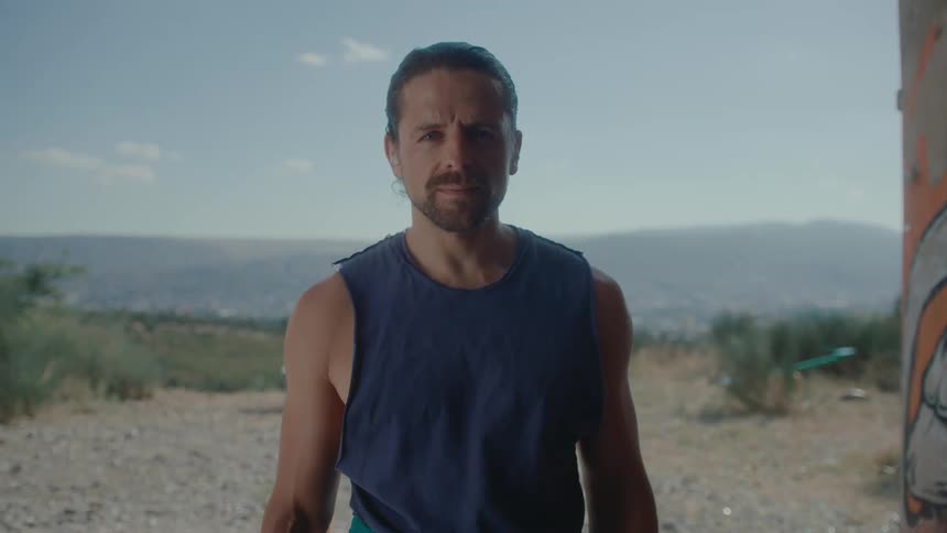 A man standing outdoor staring cautiously