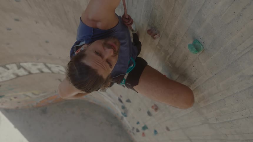 A man practicing boulder on a sunny day