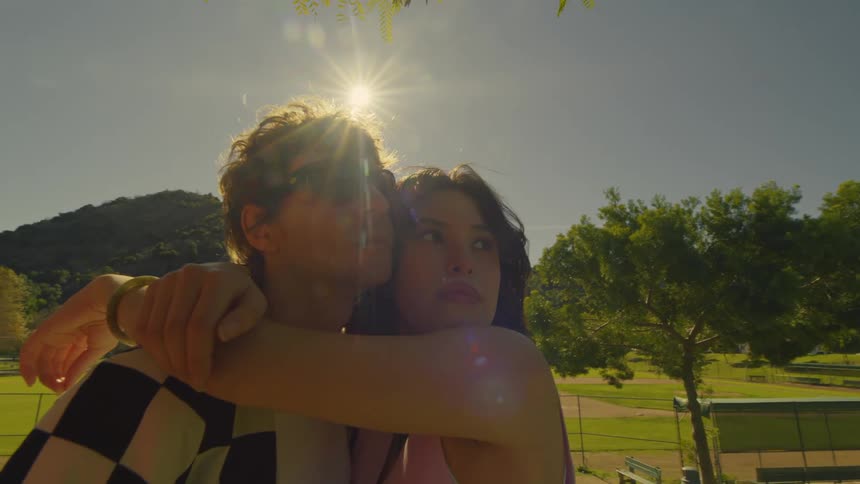 A couple hug in the park
