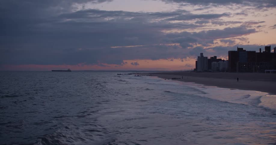 Waves washing ashore at sunset