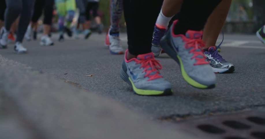 A large group of people are running together in the street