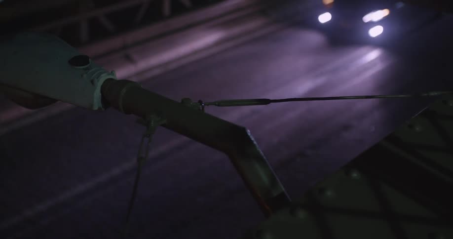 Cars drive under a streetlight