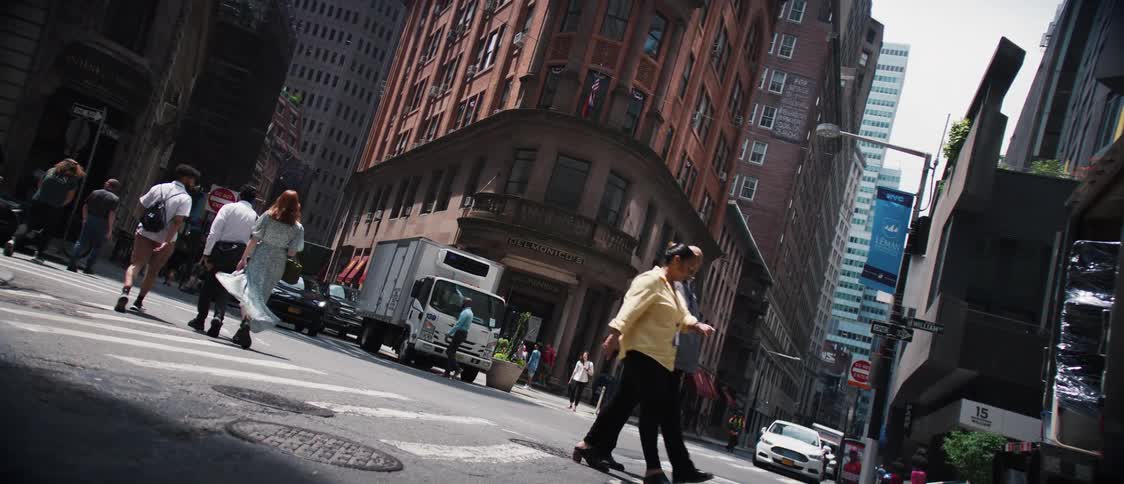 Pedestrians and vehicular traffic move through downtown intersection