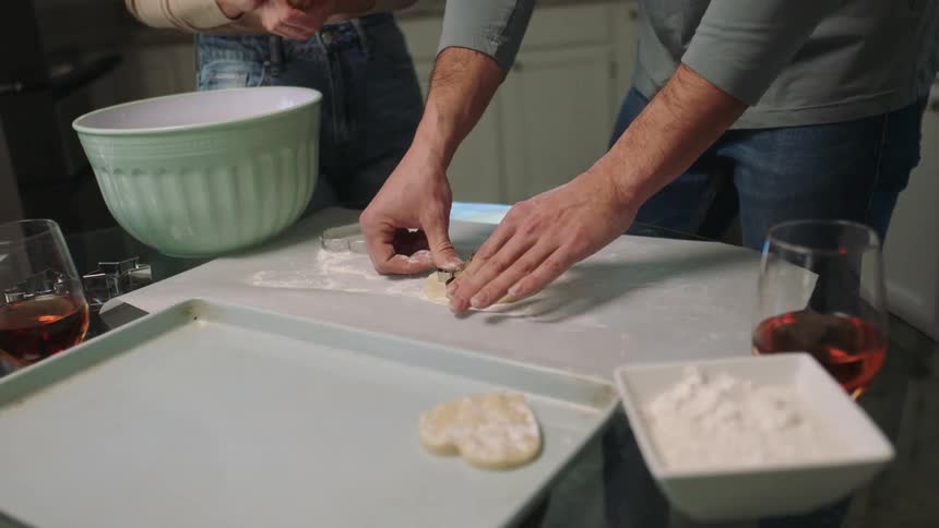 A man and a woman make cookies