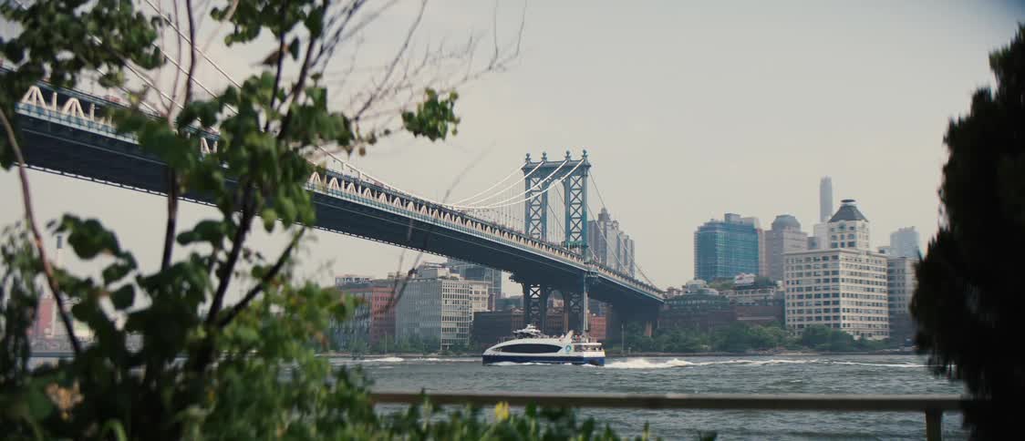 A boat travels under the bridge
