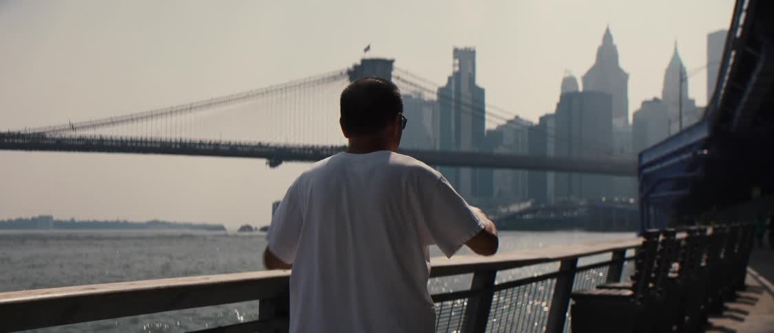 A man is stretching by the shore