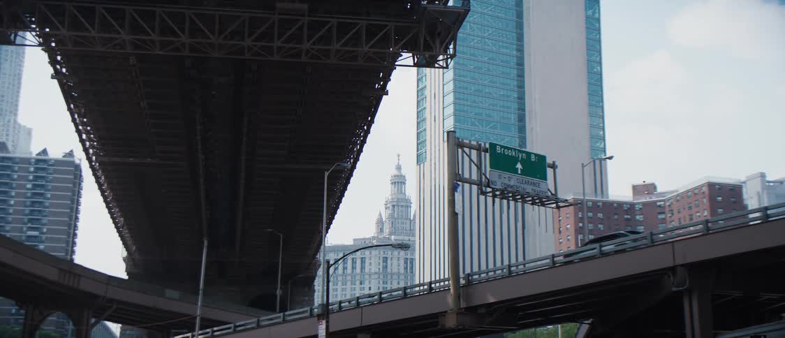 View of a viaduct with cars passing through a metropolis with skyscrapers