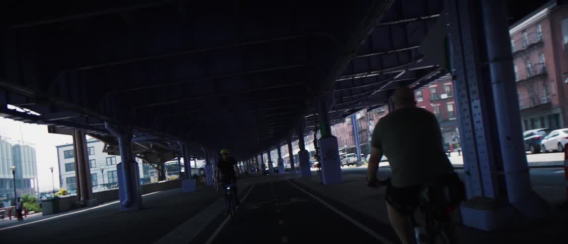 Bicycles ride under the train overpass
