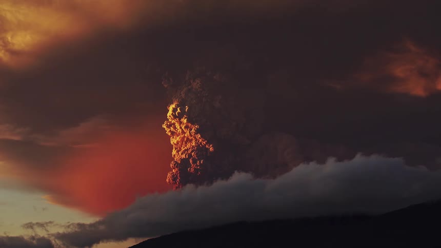 Red sky and smoke plume volcanic eruption