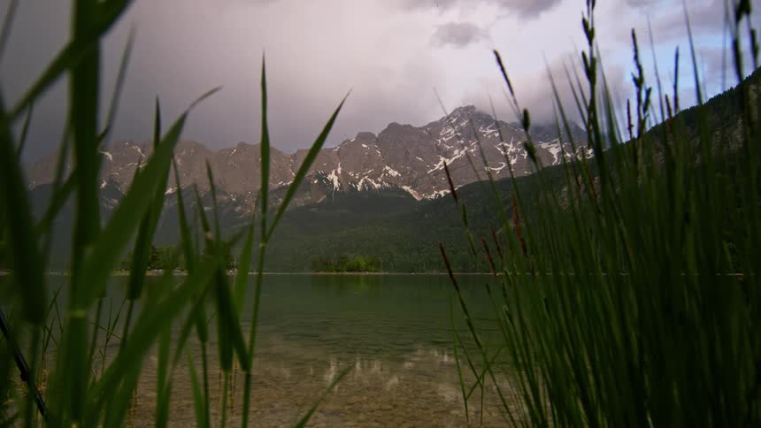 A lake with clear waters surrounded by a rocky mountain range
