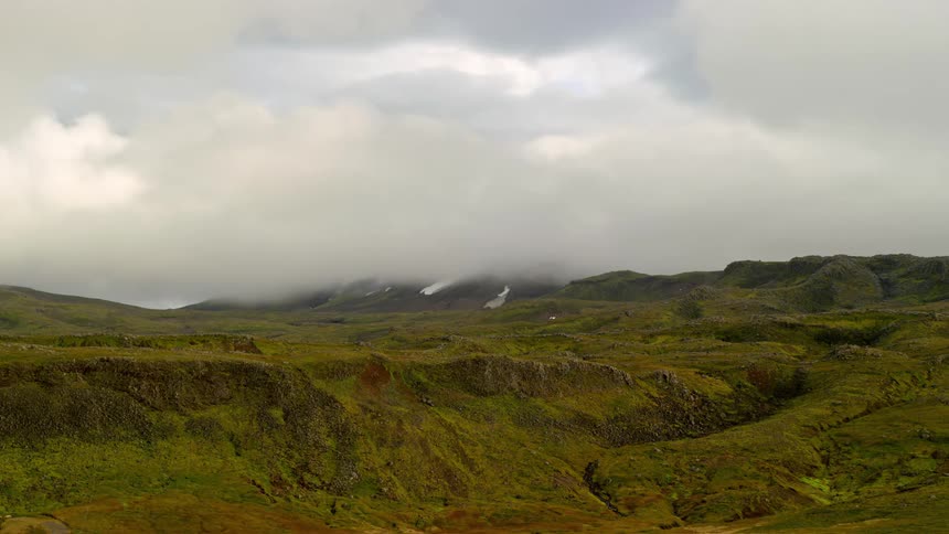 Clouds move rapidly over a mountain range