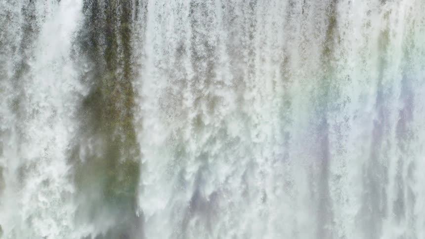 A rainbow formed over the waterfall during the hot season