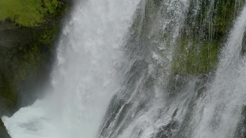 A fall of water from the top of a rock falling into a place that forms a stream