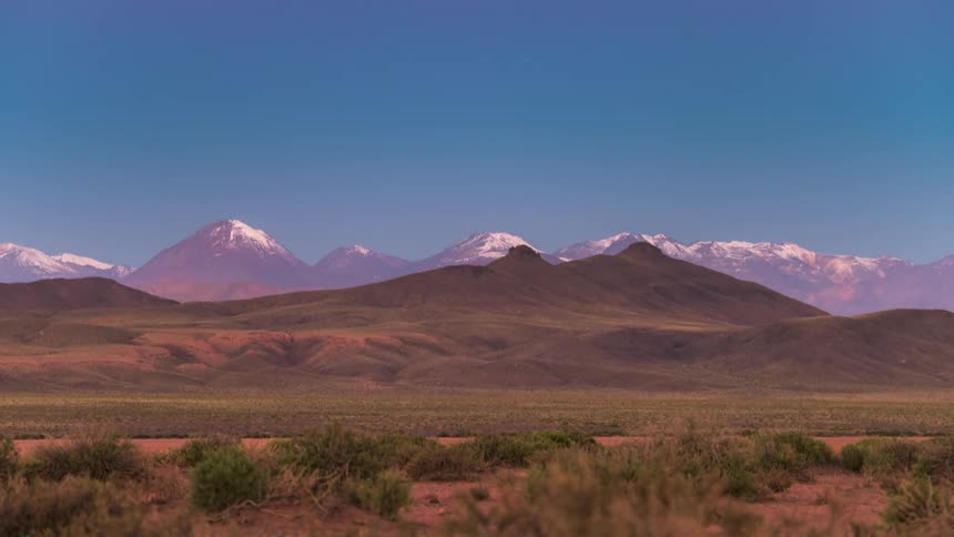 A time lapse of a day and night over some mountains