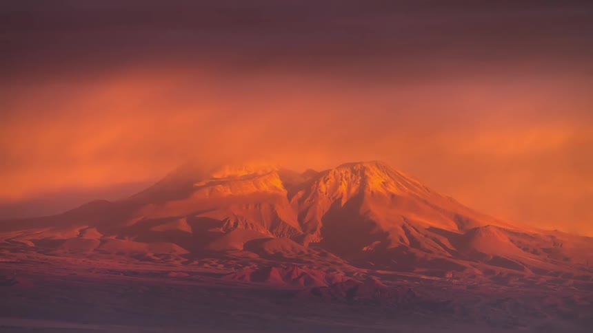 Timelapse of the day getting dark and hoarse over mountain ranges