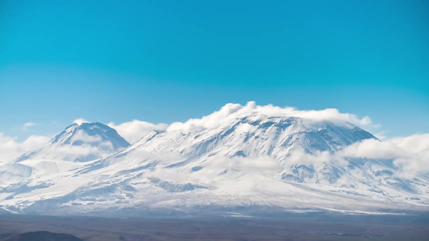 Snowcovered mountains with clouds passing in timelapse