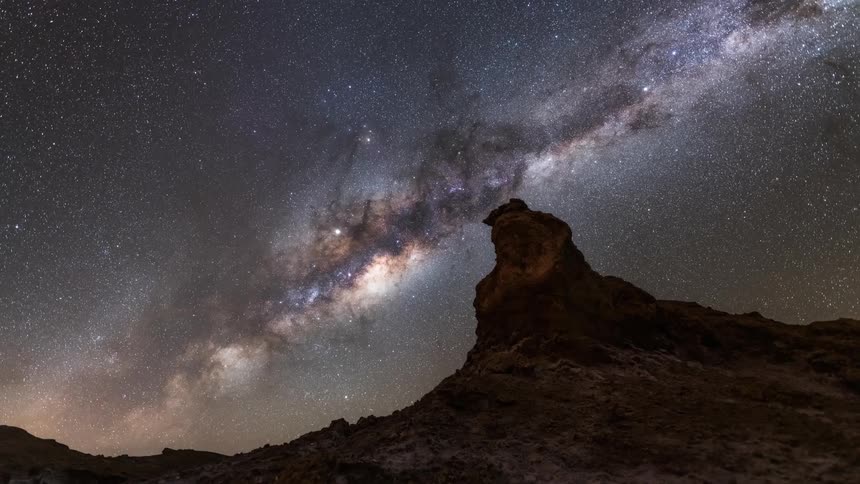 A nebula lighting up the desert sky at night