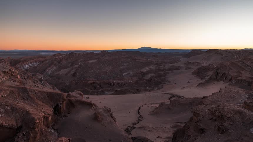Plateau and rocky mountains with a time lapse day getting dark