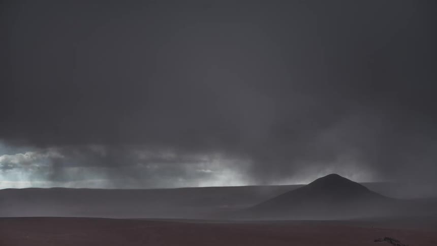 Dark storm clouds over a mountain