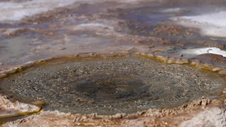 A puddle of water in a natural rock formation is moving