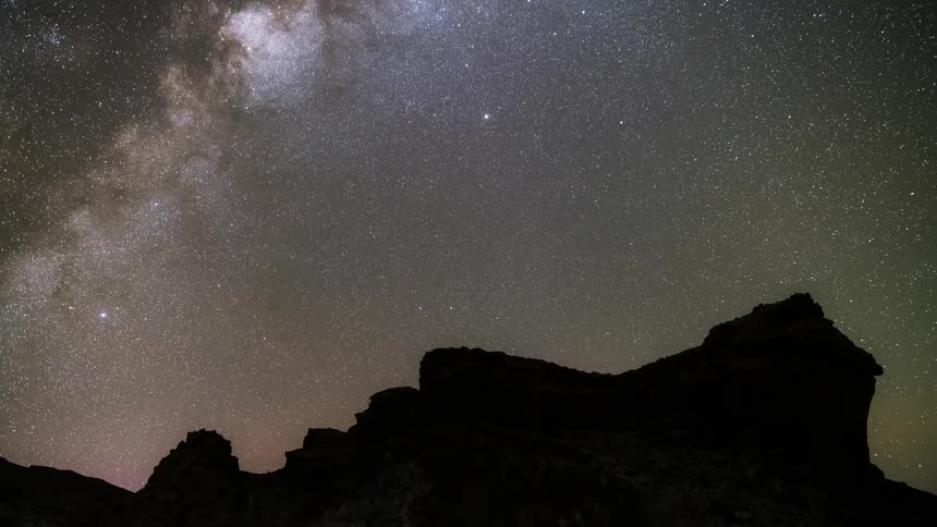 The starry sky and the milky way appearing shining while the sky is rotating