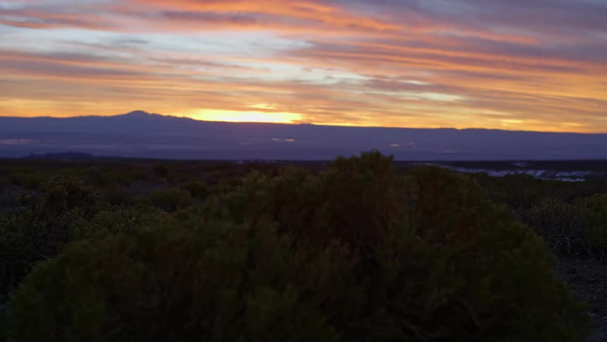 Natural landscape with the silhouette of mountains in the background against an orange sky in team alavs