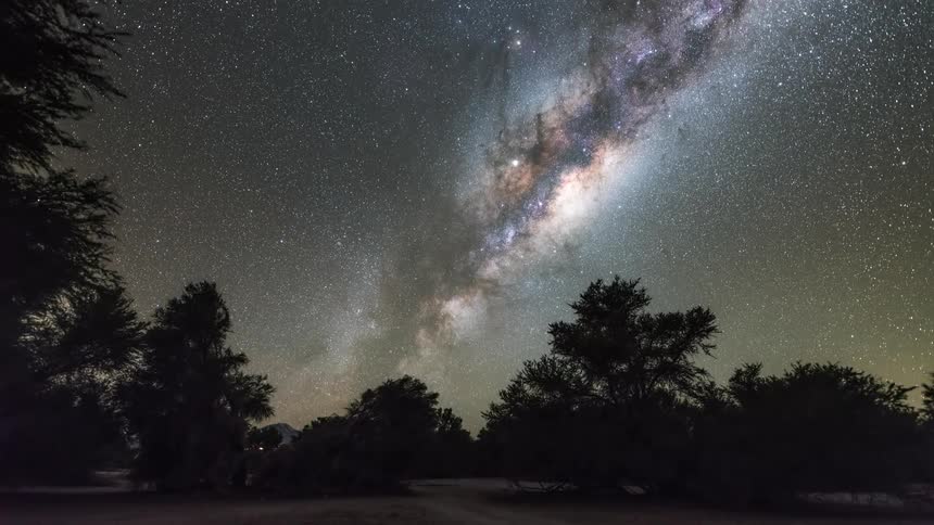 The milky way is over the forest at night