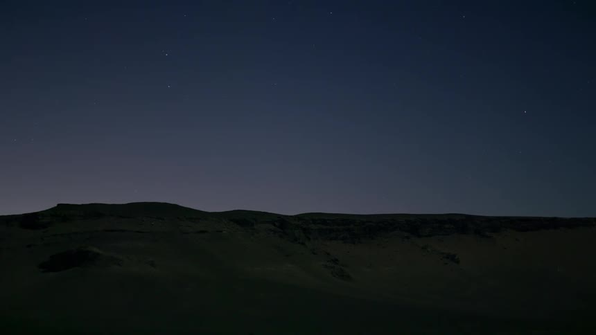 A night sky over a hilly range