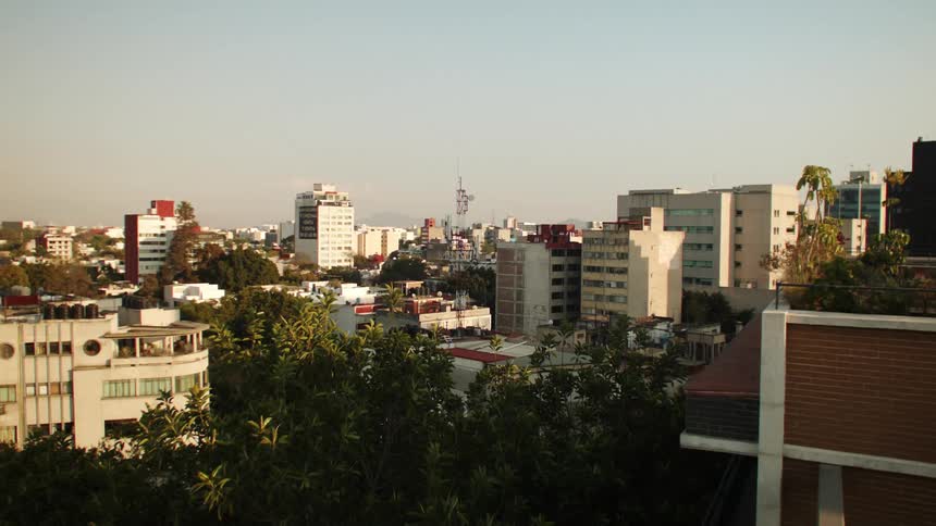A skyline showing multiple towers interspersed with trees