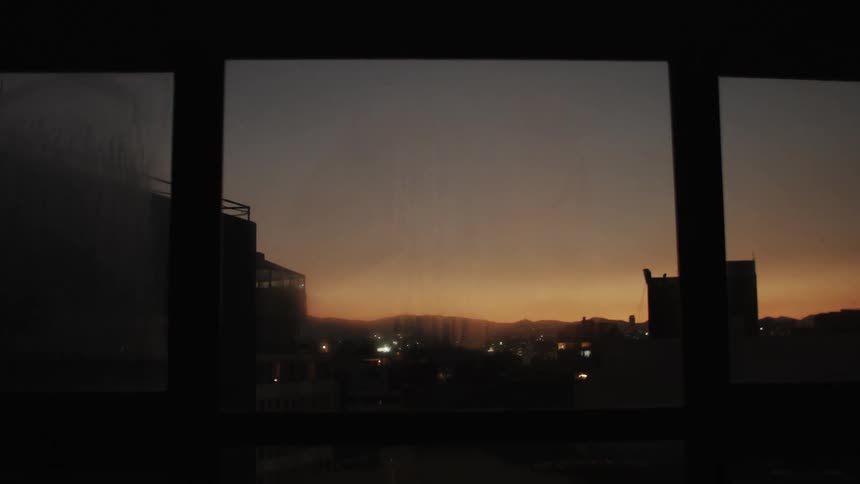 Heavy clouds are in the sky as the sun sets
