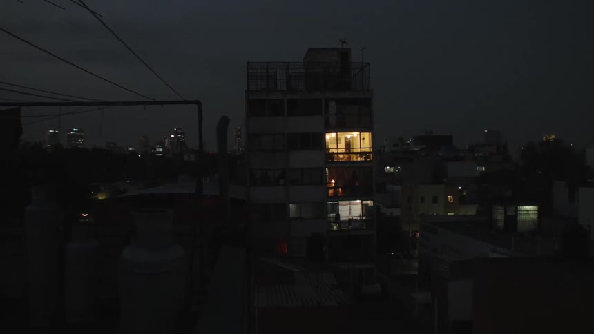 A room in a building illuminated by light at night
