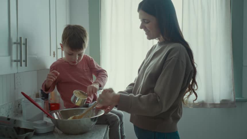 A mother and son prepare a meal