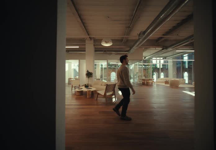 A man walks through a building lobby