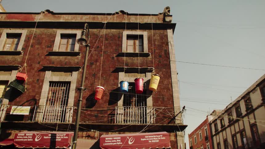 Small residential buildings with objects tied by ropes