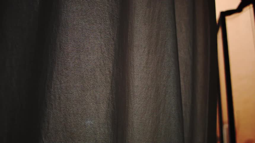A piece of fabric moves back and forth inside a building
