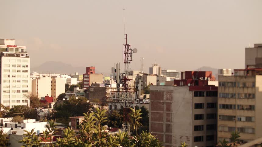 Panorama of a metropolis with buildings and the silhouette of mountains in the background