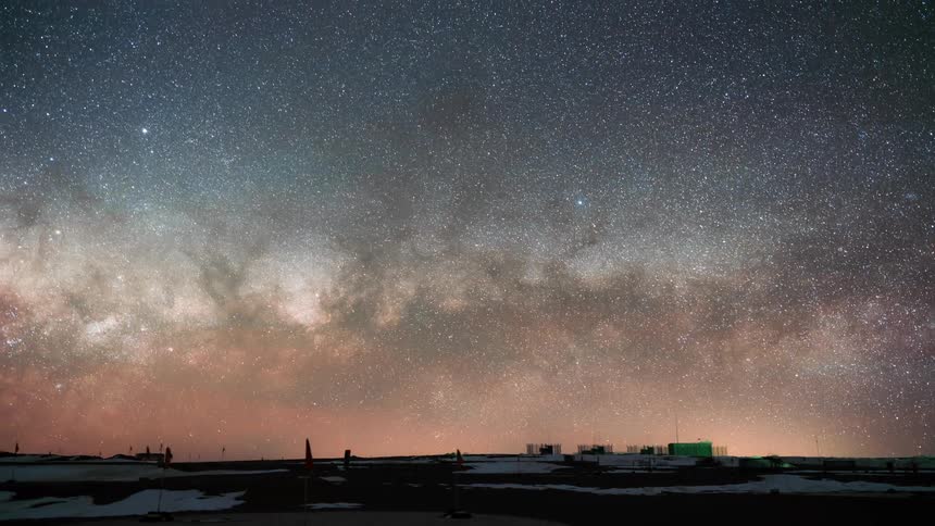 Timelapse of the night sky with stars and nebulae dawning and scientific machines like telescopes pointed at the sky
