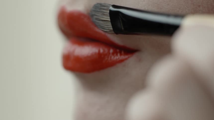Woman applying makeup to her face