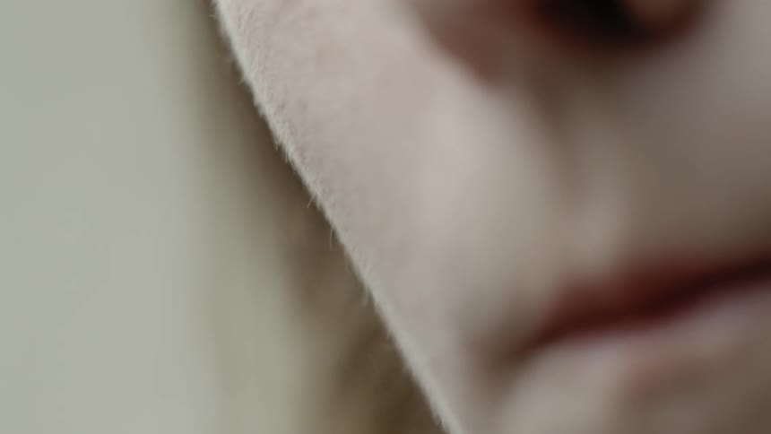Close up of a woman's cheek as she puts on blush