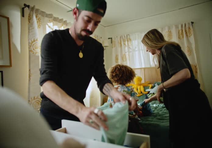 A couple help fold their daughters clothing
