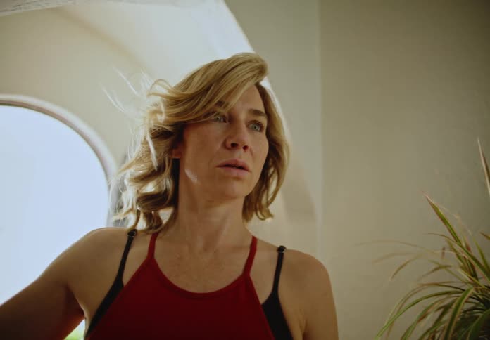A woman walking into a house