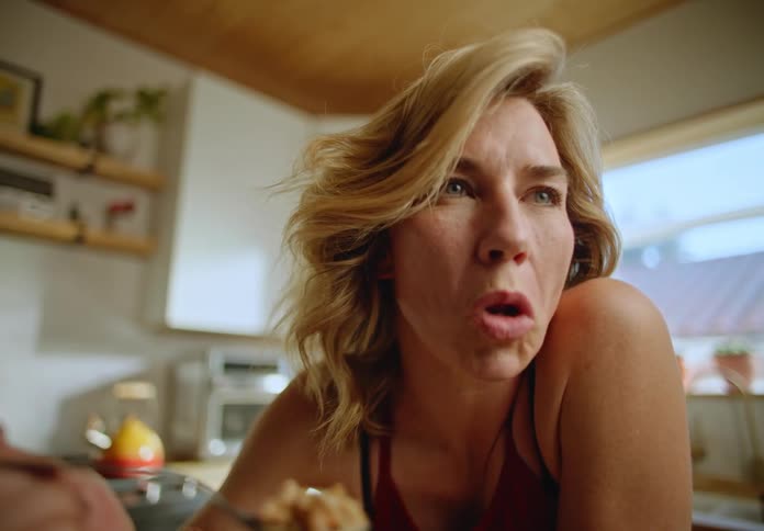 A woman is eating cereal at home