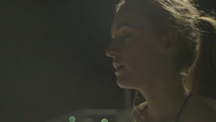 Woman outside at night staring off and panting