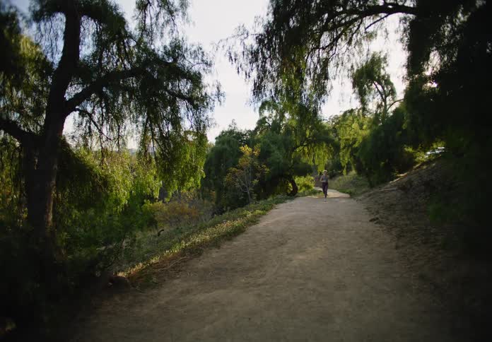 A woman runs down the path