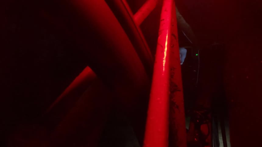Close up of the frame of a bicycle under flashing lights riding at night