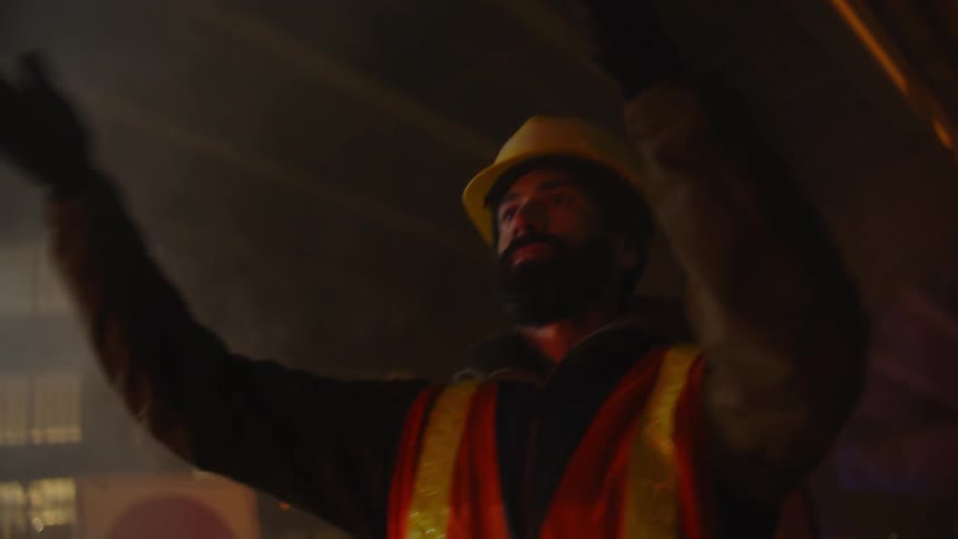 A traffic cop directing traffic during an accident in the city at night