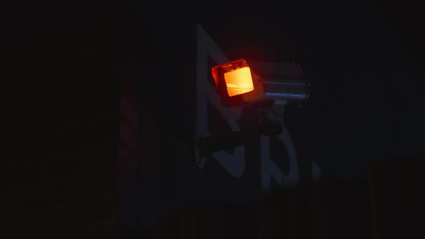 A security camera fixed to the side of a building
