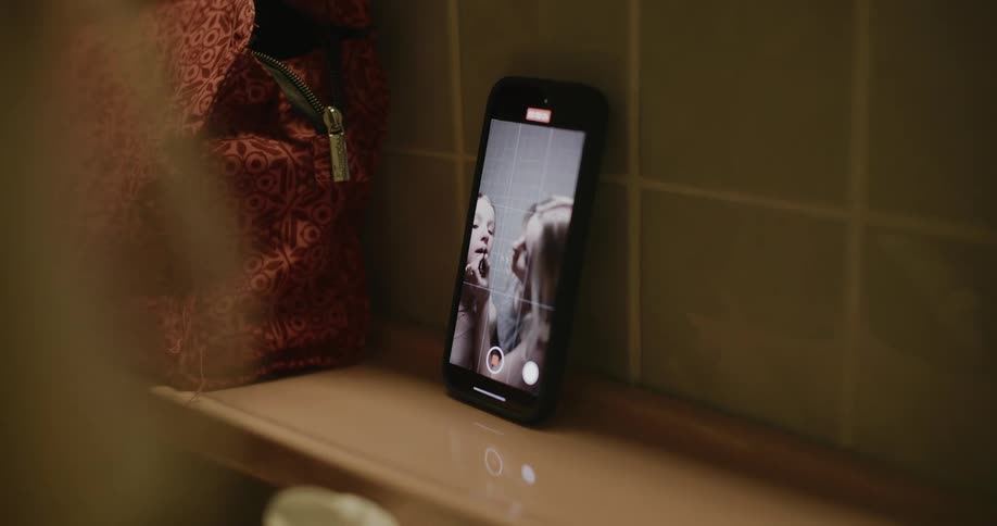 A clip of a smartphone recording some ladies during makeup