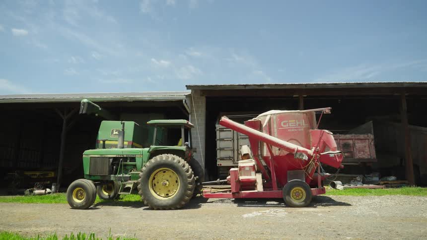 A tractor parked in front of a local factory building